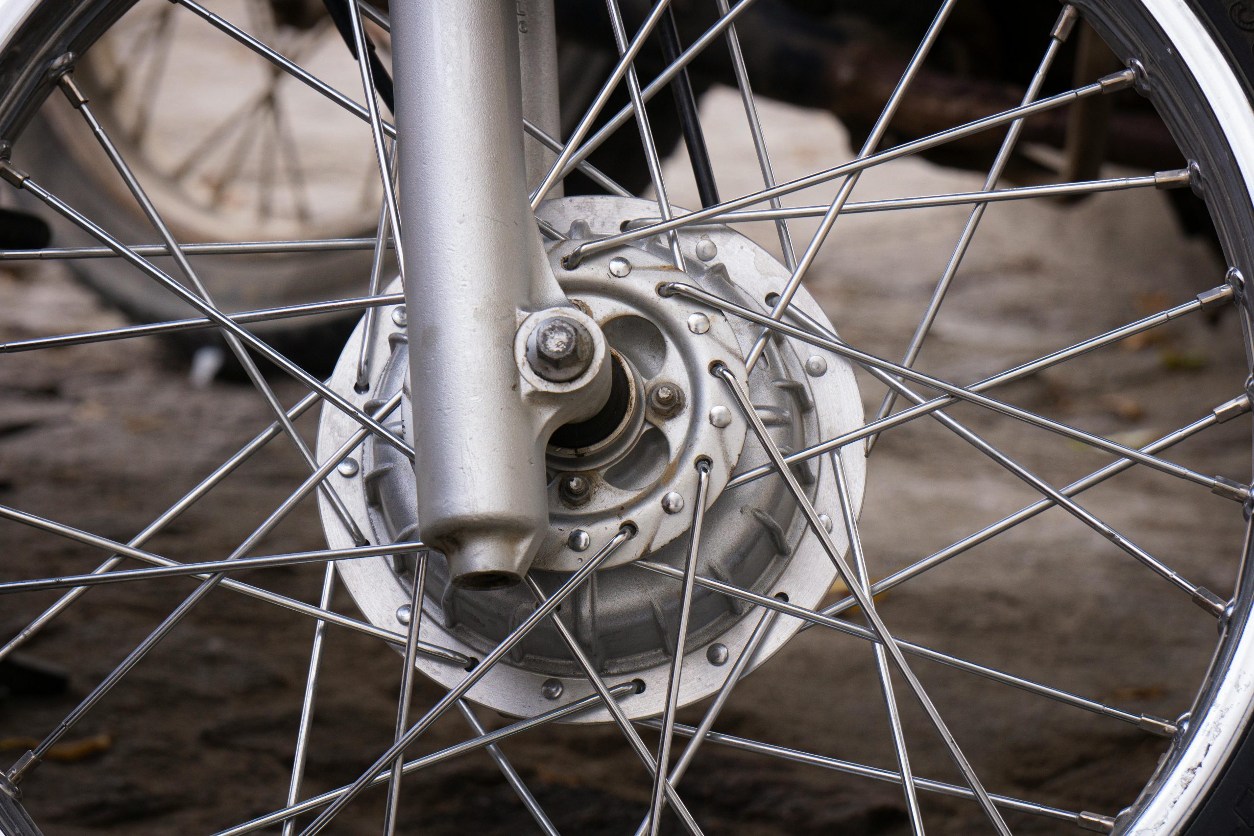 Detailed image of a motorcycle wheel showcasing spokes and hub.